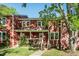 Charming two-story townhouse with red siding, white trim, and a well-maintained front yard at 127 Long Shadow Pl, Durham, NC 27713
