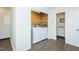 Convenient laundry room with a washer and dryer, storage shelves, and adjacent washroom at 127 Long Shadow Pl, Durham, NC 27713