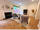 Cozy living room featuring a fireplace, plush seating, and views of the surrounding greenery at 127 Long Shadow Pl, Durham, NC 27713