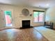 Comfortable living room with a fireplace, outdoor access, a window, and neutral paint at 127 Long Shadow Pl, Durham, NC 27713