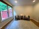 Inviting sitting area with large windows, hardwood floors, and comfortable furnishings at 127 Long Shadow Pl, Durham, NC 27713