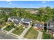 A neighborhood view with multiple craftsman-style homes and well-manicured lawns in a suburban setting under a clear blue sky at 1312 Lancaster St, Durham, NC 27701