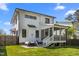 Inviting backyard features a well-maintained lawn, screened porch, and an outdoor dining area, perfect for entertaining at 1312 Lancaster St, Durham, NC 27701