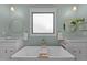 A stylish bathroom featuring double sinks, a soaking tub, and ample natural light at 1312 Lancaster St, Durham, NC 27701