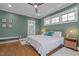 A cozy bedroom includes hardwood floors, a ceiling fan, and an ensuite bathroom at 1312 Lancaster St, Durham, NC 27701