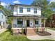 Inviting two-story home featuring a covered front porch and manicured lawn at 1312 Lancaster St, Durham, NC 27701