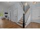 Open foyer featuring hardwood floors, staircase, and access to other rooms at 1312 Lancaster St, Durham, NC 27701