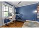Comfortable home office with a desk, treadmill, hardwood floors, and natural light at 1312 Lancaster St, Durham, NC 27701