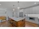 Modern kitchen with central island featuring bar seating, stainless appliances, and hardwood floors at 1312 Lancaster St, Durham, NC 27701