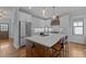 Modern kitchen featuring a spacious island, stainless steel appliances, and stylish pendant lighting at 1312 Lancaster St, Durham, NC 27701