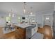 Open-concept kitchen island with seating, modern appliances, and adjacent dining area at 1312 Lancaster St, Durham, NC 27701