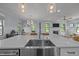 View of the kitchen sink in the island, overlooking the dining and living areas at 1312 Lancaster St, Durham, NC 27701
