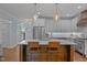 Bright kitchen boasts a large island with seating, stainless appliances, and white cabinets at 1312 Lancaster St, Durham, NC 27701