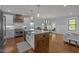 Bright, open kitchen with large island, modern appliances, and hardwood floors at 1312 Lancaster St, Durham, NC 27701