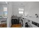 Functional laundry room with modern appliances and a folding counter at 1312 Lancaster St, Durham, NC 27701
