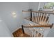 Stylish staircase with hardwood steps and white railings, bathed in natural light at 1312 Lancaster St, Durham, NC 27701