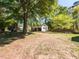 Large backyard featuring mature trees, shed, and playset at 1317 Kelly Rd, Garner, NC 27529