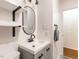 Bright bathroom with a modern vanity, updated fixtures, and open shelving at 1317 Kelly Rd, Garner, NC 27529