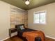 Stylish bedroom featuring a unique accent wall and modern ceiling fan at 1317 Kelly Rd, Garner, NC 27529