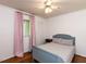 Cozy bedroom with hardwood floors, ceiling fan and window with pink curtains at 1317 Kelly Rd, Garner, NC 27529