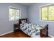 Bright bedroom with hardwood floors and two windows letting in natural light at 1317 Kelly Rd, Garner, NC 27529