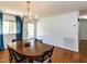 Bright dining room with hardwood floors, a classic chandelier, and ample natural light at 1317 Kelly Rd, Garner, NC 27529