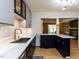 Modern kitchen featuring navy and gray cabinets, quartz countertops, and stainless steel appliances at 1317 Kelly Rd, Garner, NC 27529