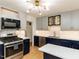 Stylish kitchen with stainless steel appliances, modern lighting, and a convenient island at 1317 Kelly Rd, Garner, NC 27529