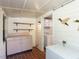 Functional laundry room with washer, dryer, shelves, and counter space for convenience at 1317 Kelly Rd, Garner, NC 27529