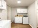 Well-equipped laundry room with modern appliances, sink, and storage cabinets at 1317 Kelly Rd, Garner, NC 27529