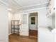 Clean laundry room with modern appliances, extra storage and entry to sunroom at 1317 Kelly Rd, Garner, NC 27529