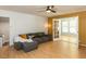 Bright living room with hardwood floors, a ceiling fan, and view into the sunroom through french doors at 1317 Kelly Rd, Garner, NC 27529