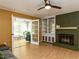 Spacious living room with a fireplace, hardwood floors, and french doors leading to the sunroom at 1317 Kelly Rd, Garner, NC 27529