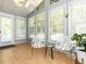 Bright sunroom with a vaulted ceiling, chandelier, and large windows offering ample natural light at 1317 Kelly Rd, Garner, NC 27529