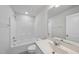 The well-lit bathroom features a tub, shower, toilet, vanity, and mirror at 1335 Herb Garden Way, Apex, NC 27502