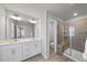 Bathroom features a glass-door shower and double vanity at 1335 Herb Garden Way, Apex, NC 27502