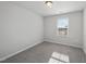 This bedroom has neutral walls, carpeted floors, and a window with natural light at 1335 Herb Garden Way, Apex, NC 27502