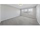 Spacious carpeted bedroom with neutral walls and plenty of natural light from the windows at 1335 Herb Garden Way, Apex, NC 27502
