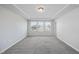 Spacious carpeted bedroom with tray ceiling and plenty of natural light from the windows at 1335 Herb Garden Way, Apex, NC 27502