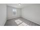 Bright empty bedroom with neutral walls, carpeted floors, and a window with natural light at 1335 Herb Garden Way, Apex, NC 27502