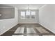 Bright dining room featuring hardwood floors, large windows, and neutral paint at 1335 Herb Garden Way, Apex, NC 27502