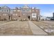 Beautiful brick townhome with welcoming entrance and well-maintained front yard at 1335 Herb Garden Way, Apex, NC 27502
