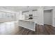 Bright, open kitchen with large island, white cabinets, and modern appliances at 1335 Herb Garden Way, Apex, NC 27502