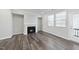 Cozy living room featuring a fireplace, neutral paint, and access to a covered patio at 1335 Herb Garden Way, Apex, NC 27502
