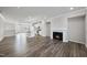 Bright open-concept living room featuring a fireplace, island, and modern kitchen with white cabinets at 1335 Herb Garden Way, Apex, NC 27502