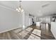 Open concept living space with hardwood floors, natural light, and modern fixtures at 1335 Herb Garden Way, Apex, NC 27502