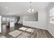 Open concept living space with hardwood floors, natural light, and modern fixtures at 1335 Herb Garden Way, Apex, NC 27502