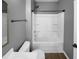 Bathroom featuring a shower-tub combo, a white vanity, a framed mirror and neutral colored walls at 136 W Tecoma Ln, Clayton, NC 27520