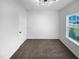 Bedroom with plush carpet, white door and a window with outside views and natural light at 136 W Tecoma Ln, Clayton, NC 27520