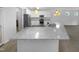 Bright kitchen with stainless steel appliances, white cabinets, and a large island with granite countertops at 136 W Tecoma Ln, Clayton, NC 27520